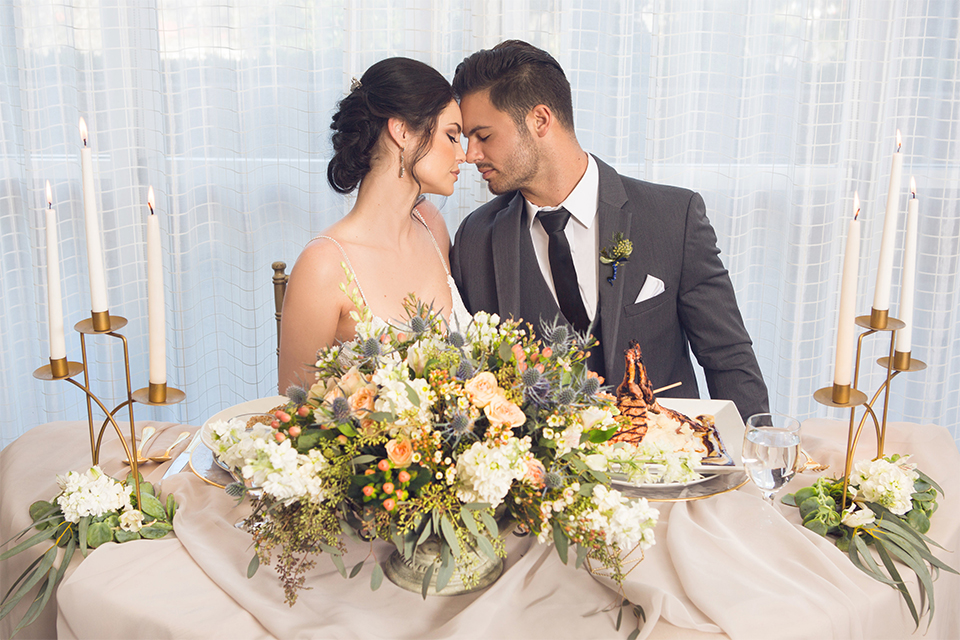 Grand-Pacific-Palisades-Groom-in-charcoal-tuxedo-with-a-long-black-tie-bride-in-a-lace-dress-with-straps