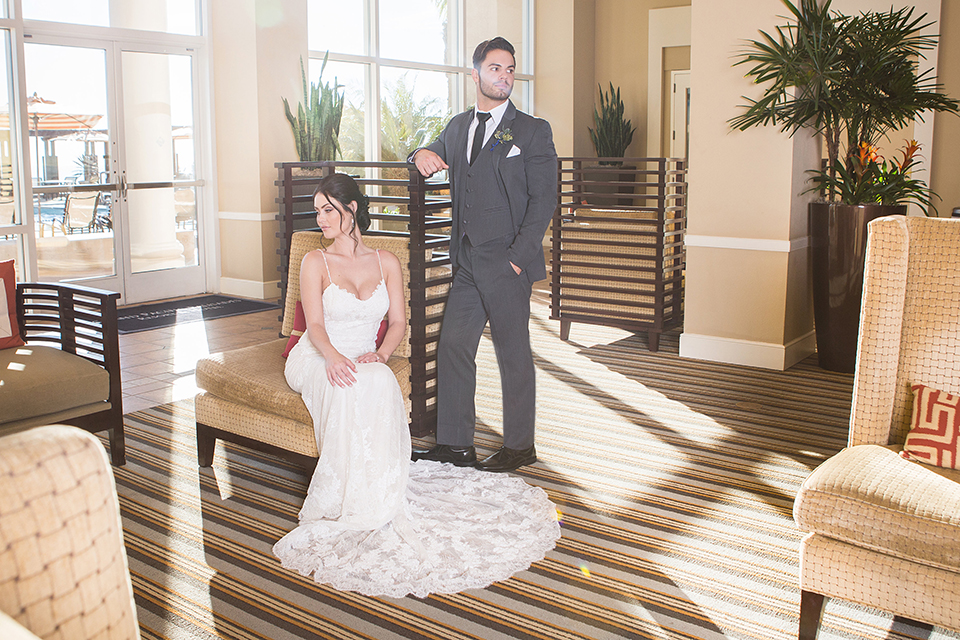 Grand-Pacific-Palisades-Groom-in-charcoal-tuxedo-with-a-long-black-tie-bride-in-a-lace-dress-with-straps