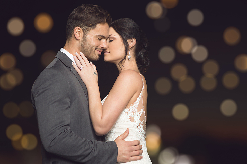 Grand-Pacific-Palisades-Groom-in-charcoal-tuxedo-with-a-long-black-tie-bride-in-a-lace-dress-with-straps