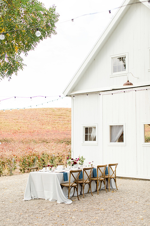 hammersky-editorial-shoot-outdoor-set-up-white-barn-with-wooden-chairs-and-white-linen