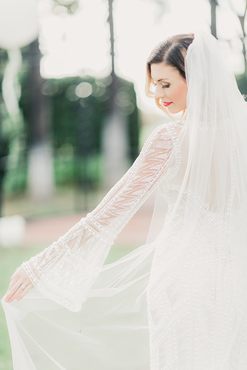 MUCKENTHALER-SHOOT-bride-twirling-bride-in-fitted-satin-long-sleeve-gown