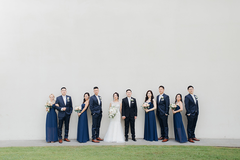 occidental-college-wedding-bridal-party-groom-in-black-tuxedo-bride-in-a-fitted-gown-with-a-beaded-bodice-bridesmaids-in-blue-gowns