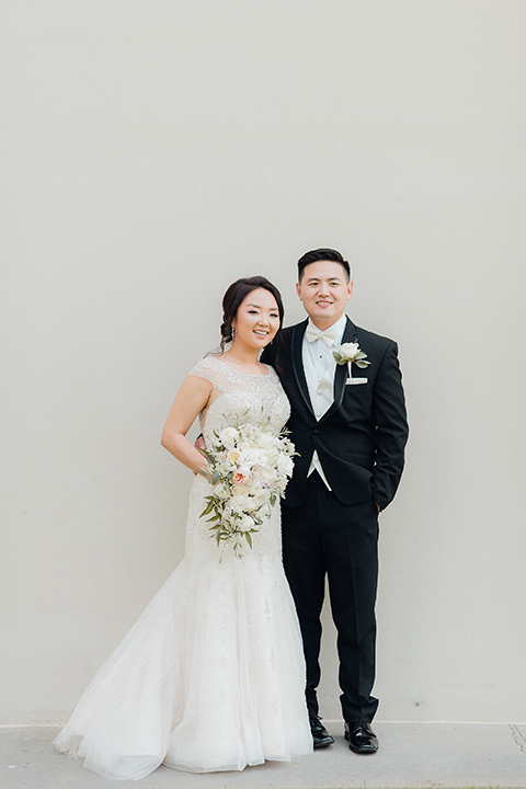 occidental-college-wedding-bride-and-groom-standing-groom-in-black-tuxedo-bride-in-a-fitted-gown-with-a-beaded-bodice