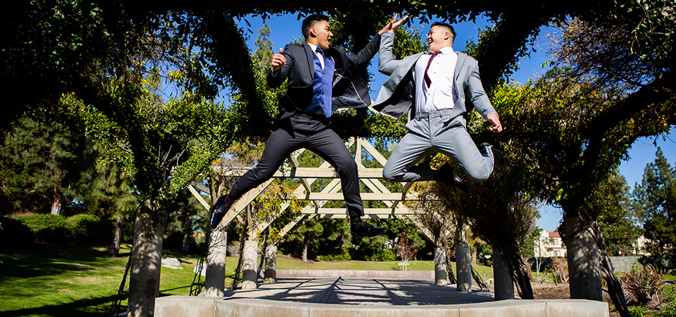 michael-kors-high-five-one-model-is-in-a-light-grey-suit-and-the-other-is-in-the-charcoal-suit-prom-looks-for-guys