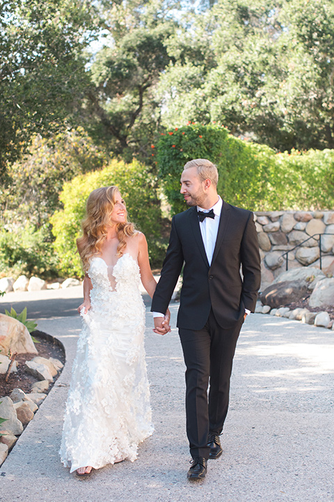 rockwood-shoot-bride-and-groom-walking-bride-in-a-ball-gown-with-hair-in-a-retro-inspired-finger-wave-groom-in-a-traditional-black-tuxedo-with-black-bow-tie