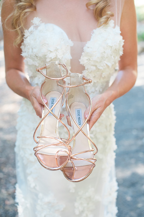 rockwood-shoot-bride-holding-shoes-bride-in-a-ball-gown-holding-gold-heels