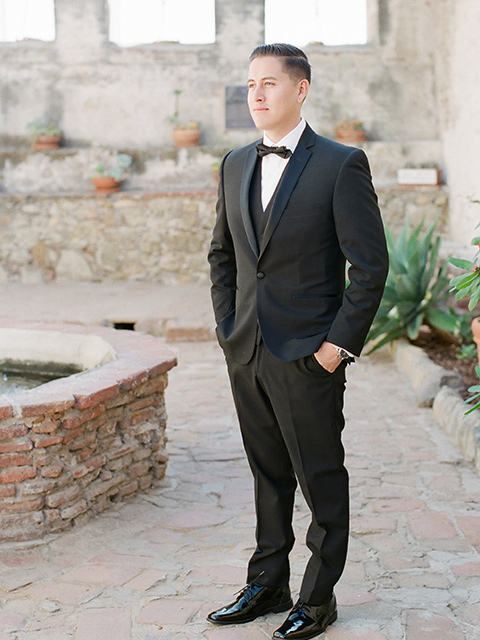 san-juan-capastrano-wedding-groom-standing-groom-in-a-black-tuxedo-with-black-bow-tie