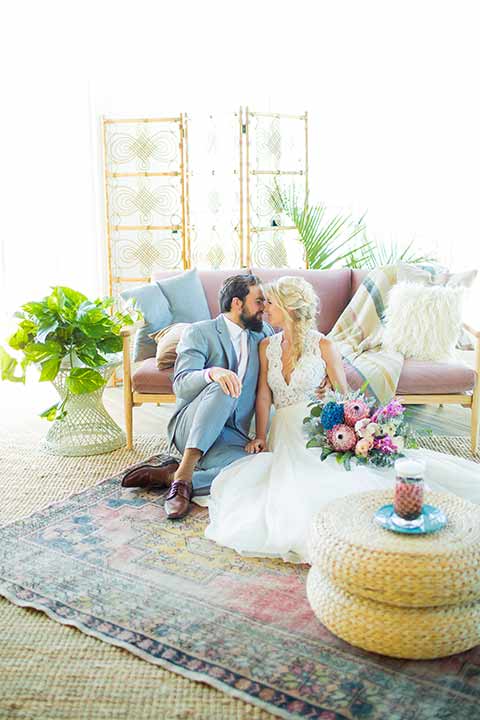 seapoint-bridal-shoot-bride-and-groom-on-the-floor-bride-in-a-lace-gown-with-thick-lace-straps-and-hair-in-a-loose-braid-groom-in-a-light-grey-suit-with-a-white-long-tie