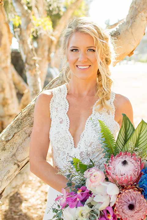 seapoint-bridal-shoot-close-up-on-bride-bride-in-a-lace-gown-with-thick-lace-straps-and-hair-in-a-loose-braid