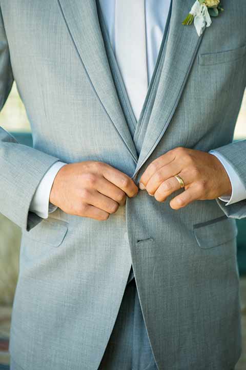 seapoint-bridal-shoot-close-up-on-the-suit-groom-in-a-light-grey-suit-with-a-white-long-tie