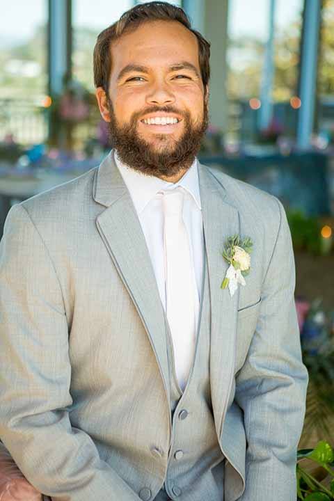 seapoint-bridal-shoot-groom-smiling-close-up-groom-in-a-light-grey-suit-with-a-white-long-tie