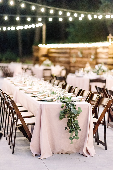 skypark-styled-shoot-string-lights-and-ceremony-space-pink-linens-and-brown-wooden-chairs