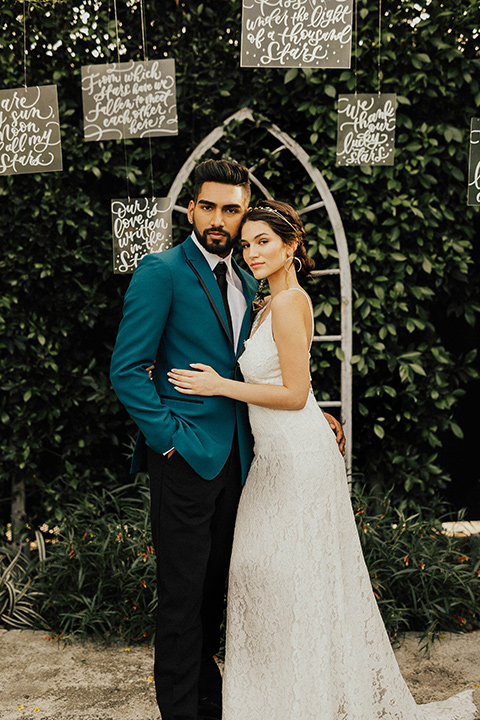 The-Ruby-Street-photoshoot-bride-and-groom-at-ceremony-groom-in-a-teal-tuxedo-jacket-with-black-pants-and-a-black-bowtie