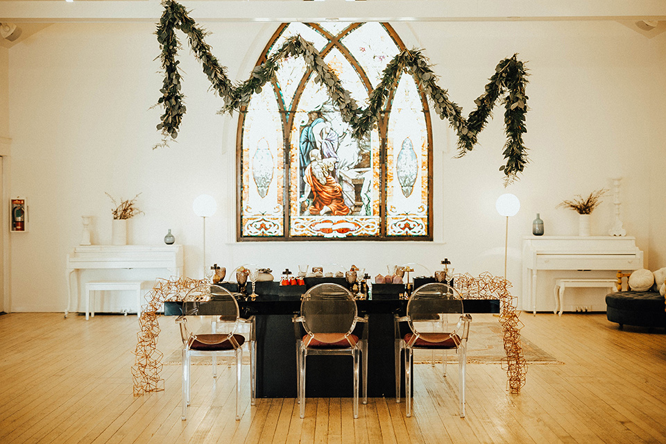 The-Ruby-Street-photoshoot-reception-table-set-up-with-a-black-table-and-gold-chairs