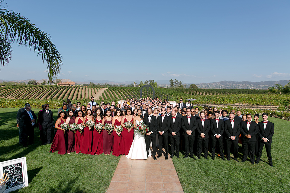 Villa-de-Amore-everyone-attending-the-wedding-bridesmaids-in-pink-dresses-groomsmen-in-black-tuxedos