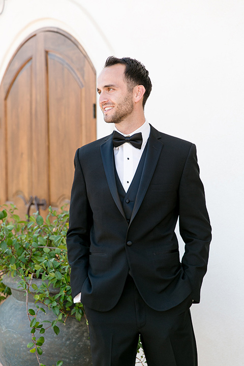 Villa-de-Amore-groom-standing-alone-groom-in-a-black-tuxedo