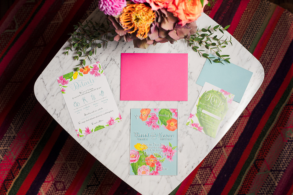 Aliso Viejo wedding design with white invitations with colorful floral invitations