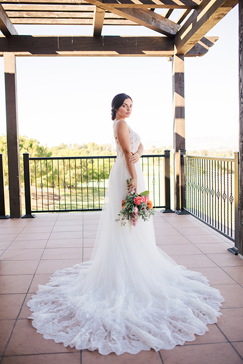 aliso viejo wedding design with the bride in a lace white gown with thin straps and a full skirt