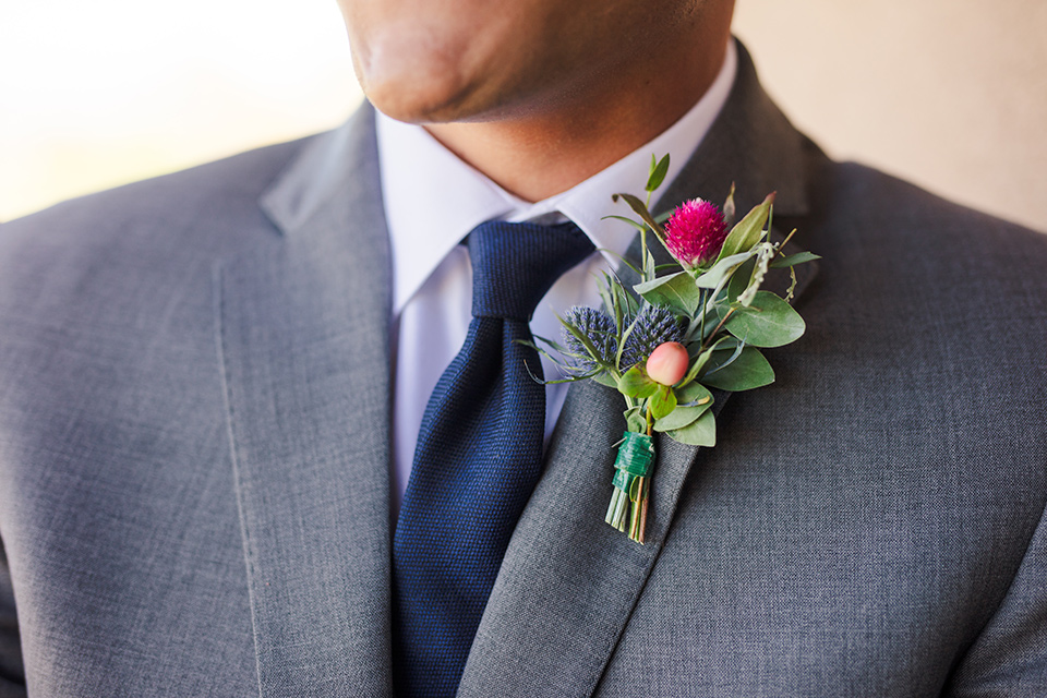 Aliso Viejo wedding design the groom in a grey suit with a blue neck tie