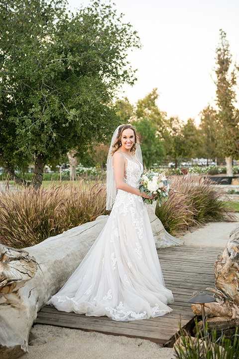 Garden-Wedding-bride-in-a-strapless-ballgown-with-her-hair-down-in-a-loose-wave