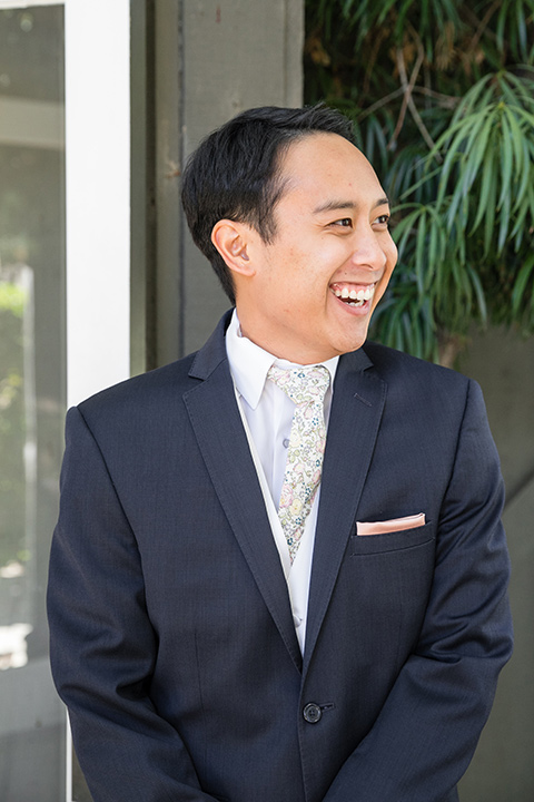 Garden-Wedding-groom-in-a-navy-suit-with-a-white-long-tie-and-pink-pocket-square