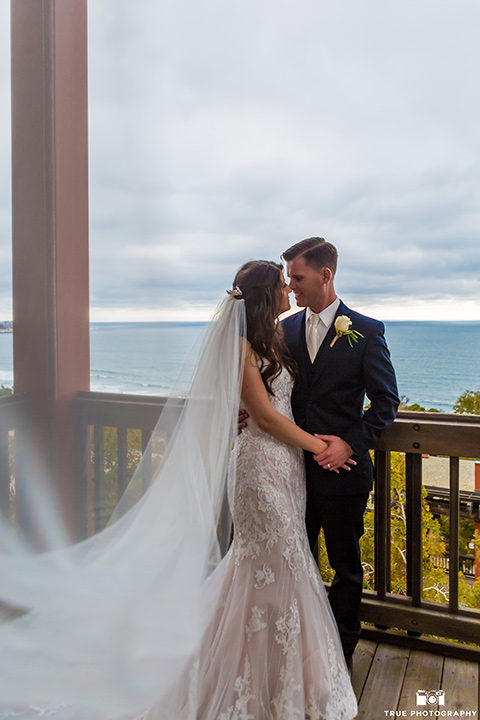 bride and groom pose on a balcony in La Jolla