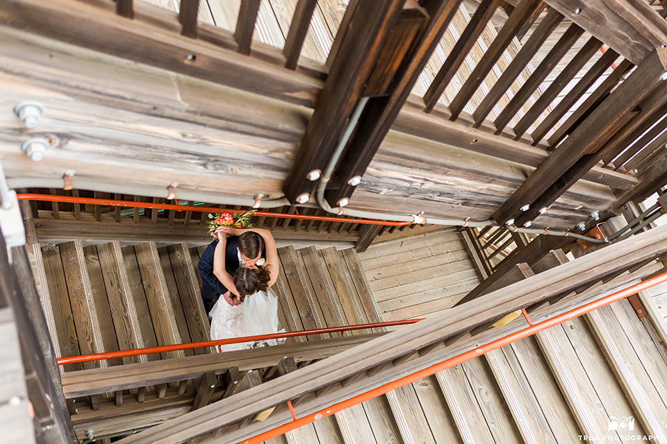 birds eye view of bride and groom kissing on stairs