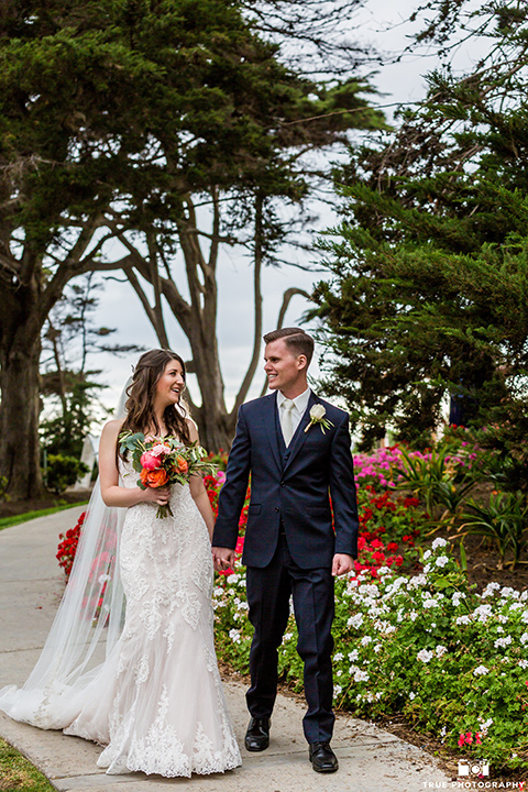 Bride and groom walking towards camera in La Jolla