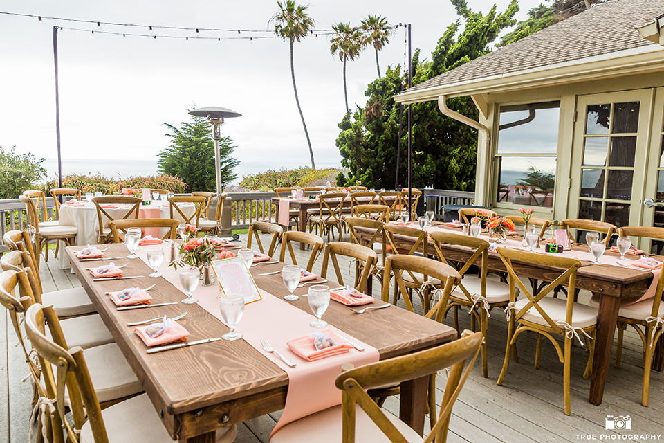 Martin Johnson House wedding reception space with wooden picnic tables and coral details