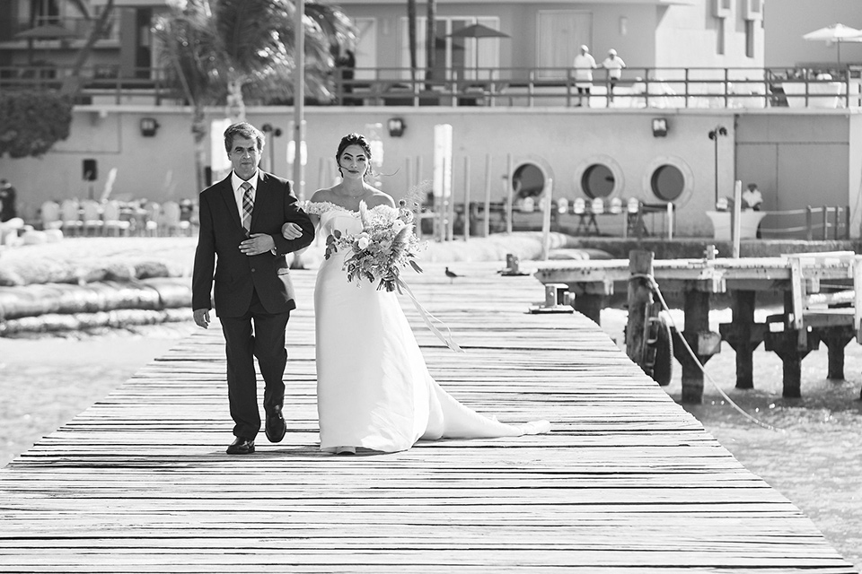 Grand-Firesta-Americana-Coral-Beach-bride-coming-down-aisle