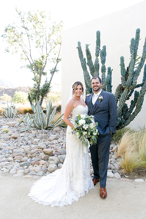 gallaway-downs-bride-and-groom-by-cacti-bride-in-a-lace-a-line-gown-with-a-modified-sweetheart-neckline-groom-in-a-dark-blue-suit-with-a-white-long-tie