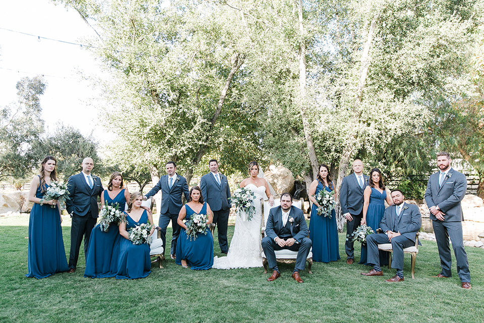 gallaway-downs-wedding-bridal-party-cheering-the-bridesmaids-in-royal-blue-gowns-groomsmen-in-navy-blue-suits-bride-in-a-lace-a-line-gown-and-groom-in-a-navy-blue-suit-with-a-white-long-tie