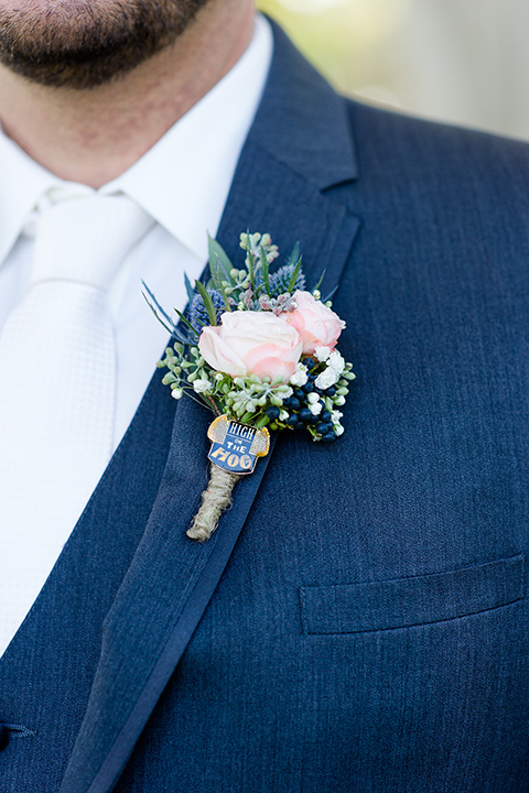 gallaway-downs-wedding-close-up-on-groom-attire-in-a-dark-blue-suit-with-a-white-long-tie