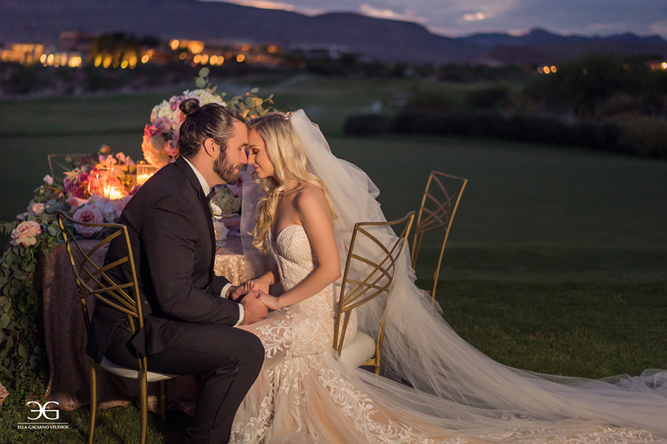 Bears-Best-Venue-Wedding-Shoot-bride-and-groom-touching-heads-sitting-at-sweetheart-table-bride-in-a-lace-mermaid-gown-and-groom-in-a-black-tuxedo