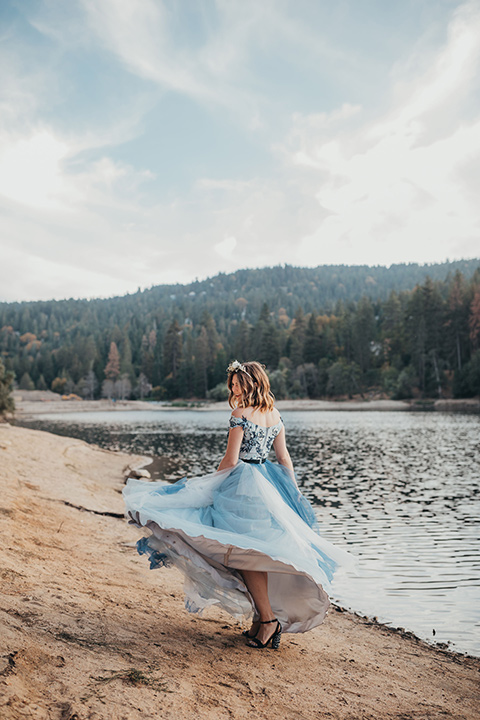 Big-Bear-Elopement-Shoot-bride-spinning-bride-wearing-a-blue-tulle-gown-with-an-illusion-neck-line-and-floral-design-groom-with-black-tuxedo-and-black-bow-tie