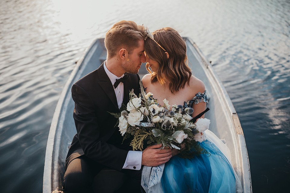 blue-tulle-gown-with-an-illusion-neckline-and-floral-design-the-groom-wore-a-traditional-black-tuxedo-with-a-peak-lapel-and-black-bow-tie