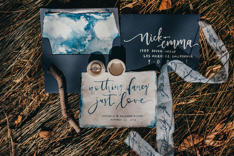 Big-Bear-Elopement-Shoot-invitations-in-different-shades-of-blue-with-calligraphy