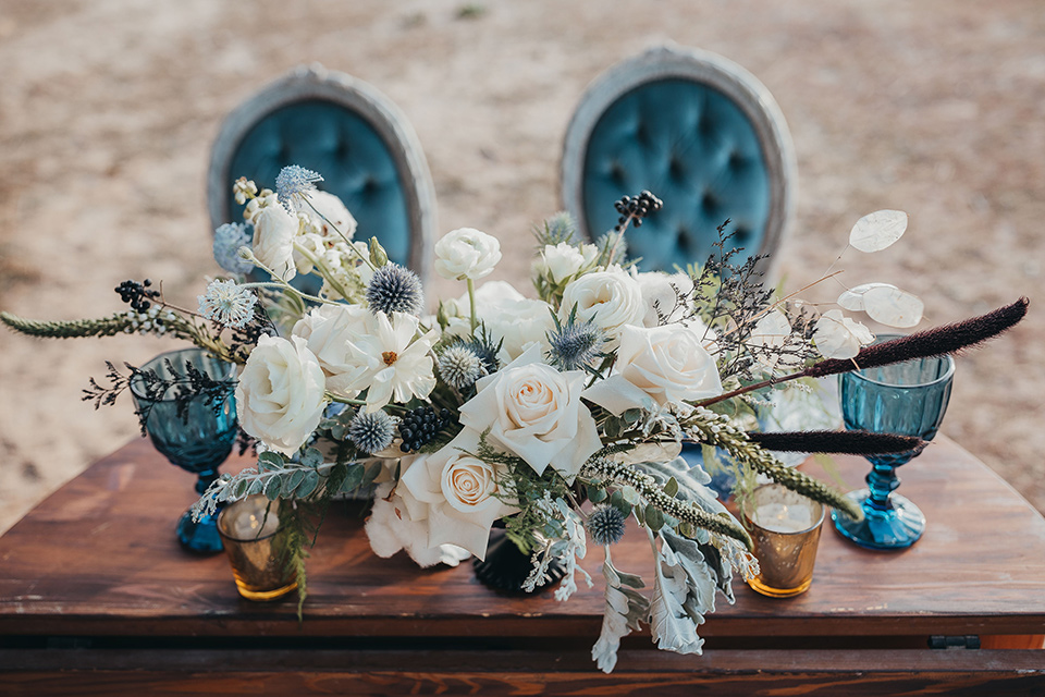 Big-Bear-Elopement-Shoot-table-setup-with-blue-velvet-chairs-and-a-wooden-table