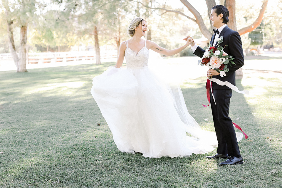 Bride and groom running in the ranch 