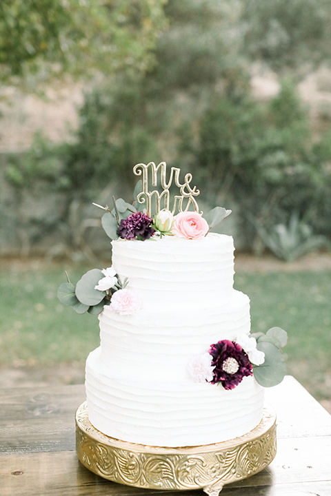 wedding cake in white fondant and simple flower decor