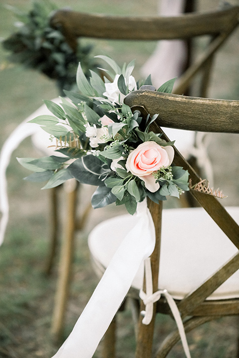 Blomgren Ranch Wedding ceremony wooden chairs with simple white florals