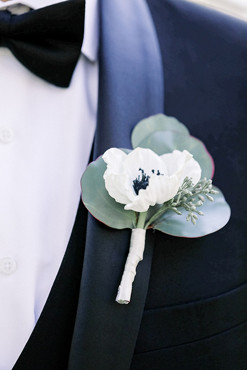 Close up of groom's shawl lapel tuxedo with a Boutonnière