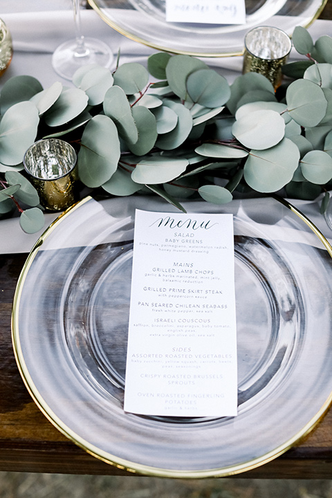 Blomgren Ranch wedding table décor with silver plates and white menu cards