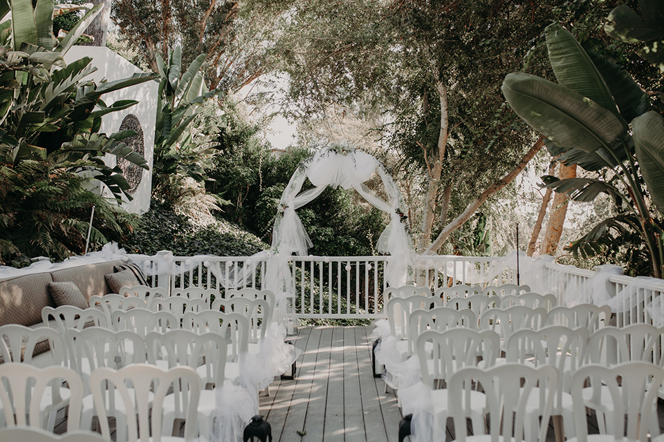 West-Hollywood-Wedding-ceremony-set-up-with-white-chairs-and-white-archway