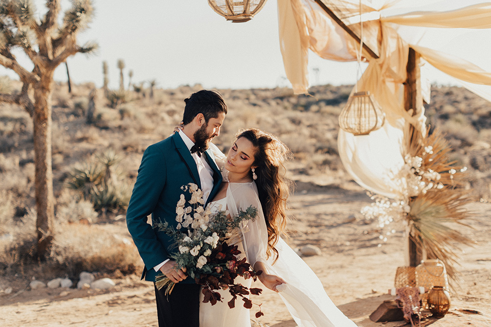 Groom holds flowers with the bride 