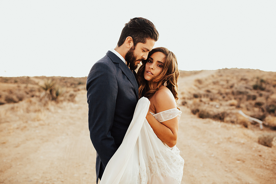 Bride and groom pose for a wedding photo in Joshua Tree