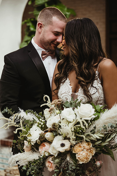 The-Ebell-In-Long-Beach-Wedding-bride-and-groom-close-bride-in-a-champagne-ballgown-with-a-strapless-neckline-and-the-groom-in-a-black-tuxedo-with-a-rose-gold-bow-tie