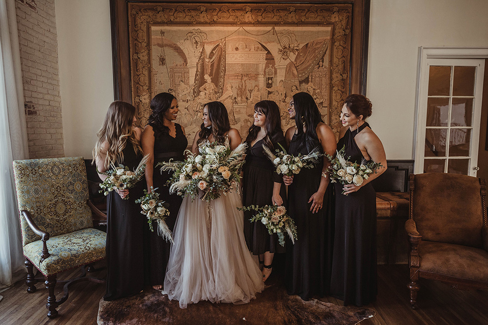 The-Ebell-In-Long-Beach-Wedding-bridesmaids-in-long-black-dresses-and-the-bride-in-a-glamourous-strapless-ballgown