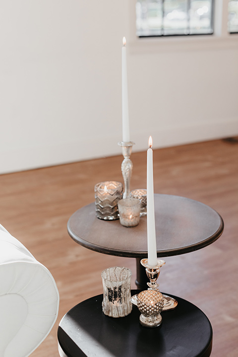 Building-177-Styled-Shoot-candles-on-coffee-table-with-tall-white-candles-and-gold-decor