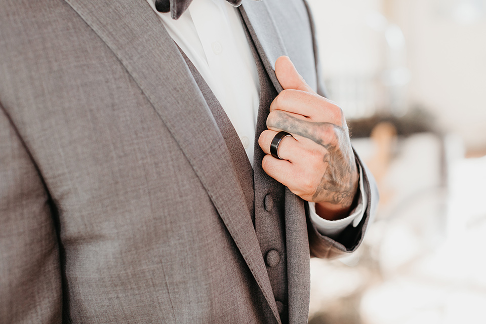 Building-177-Styled-Shoot-close-up-on-groom-attire-in-a-grey-suit-with-a-grey-velvet-bow-tie-and-black-onyx-ring